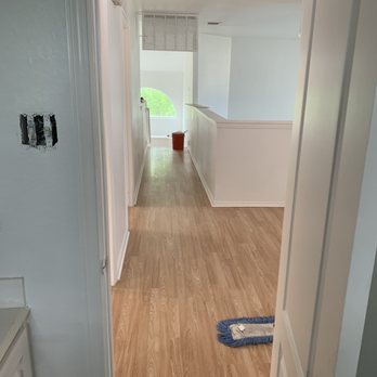 E&E Flooring Specialists  - a hallway leading to a kitchen - Flooring Near Me