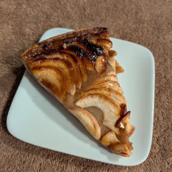La Vieille France - Tart aux pommes - a french pastry with sliced apples on top of an apple puree/sauce with flaky crust.