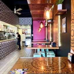 Lupe's Mexican Eatery - Dining area with splashes of color and geometric patterns on the table and walls. Kitchen is to the left.