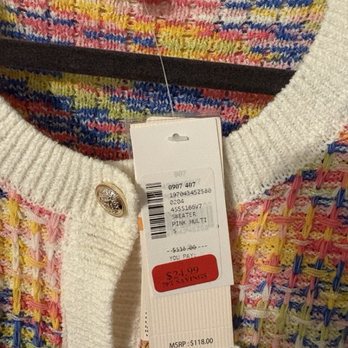 Saks OFF 5TH - Fall 2025, Nanette Lepore cardigan on final sale. - The image shows a Nanette Lepore sweater with a multicolored, textured pattern featuring pink, yellow, blue, and other colors. The sweater has a white knit collar and decorative metallic buttons. Attached to the sweater are tags displaying the brand, size, and pricing information, including a sale price of $24.99 from an original MSRP of $118.00. The tags indicate the sweater is a pink multi-color design, and the photo appears to be taken in a retail setting, likely Saks OFF 5TH in Glendale, AZ. - Department Stores Near Me - Glendale, Arizona