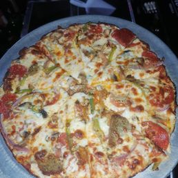 Bar pie with various meats, peppers and onions