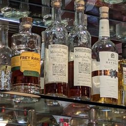 bottles of alcohol on a glass shelf bottles of alcohol on a glass shelf