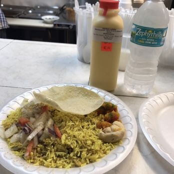 Spice N Curry - Yellow fried rice. Papadum, piece of Ladu and piece of Barfi. Mango lassi. - Indian Near Me - Miami, Florida Spice N Curry - Yellow fried rice. Papadum, piece of Ladu and piece of Barfi. Mango lassi. - Indian Near Me - Miami, Florida
