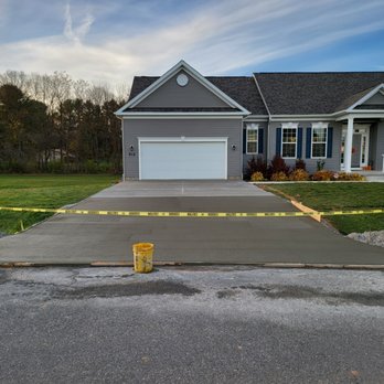 Bullfrog Contracting - a driveway with a yellow caution tape - Masonry/Concrete Near Me