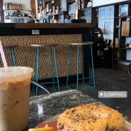 Iced oat milk latte and bagel sandwich with smoked salmon