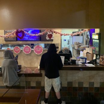 Round Table Pizza - two people standing at the counter - Pizza Near Me - Benicia, California Round Table Pizza - two people standing at the counter - Pizza Near Me - Benicia, California