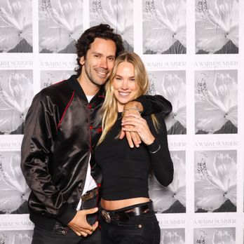 Nixie Photo Booth - A smiling couple poses closely together in front of an "A Warm Summer" backdrop. - Photo Booth Rentals Near Me - Ontario, California