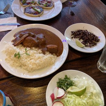 Caadxi Oaxaca - From top to bottom:  Sopes  Molé (left) + grasshopper (right)  Posolé toppings - Mexican Near Me - Snoqualmie, Washington