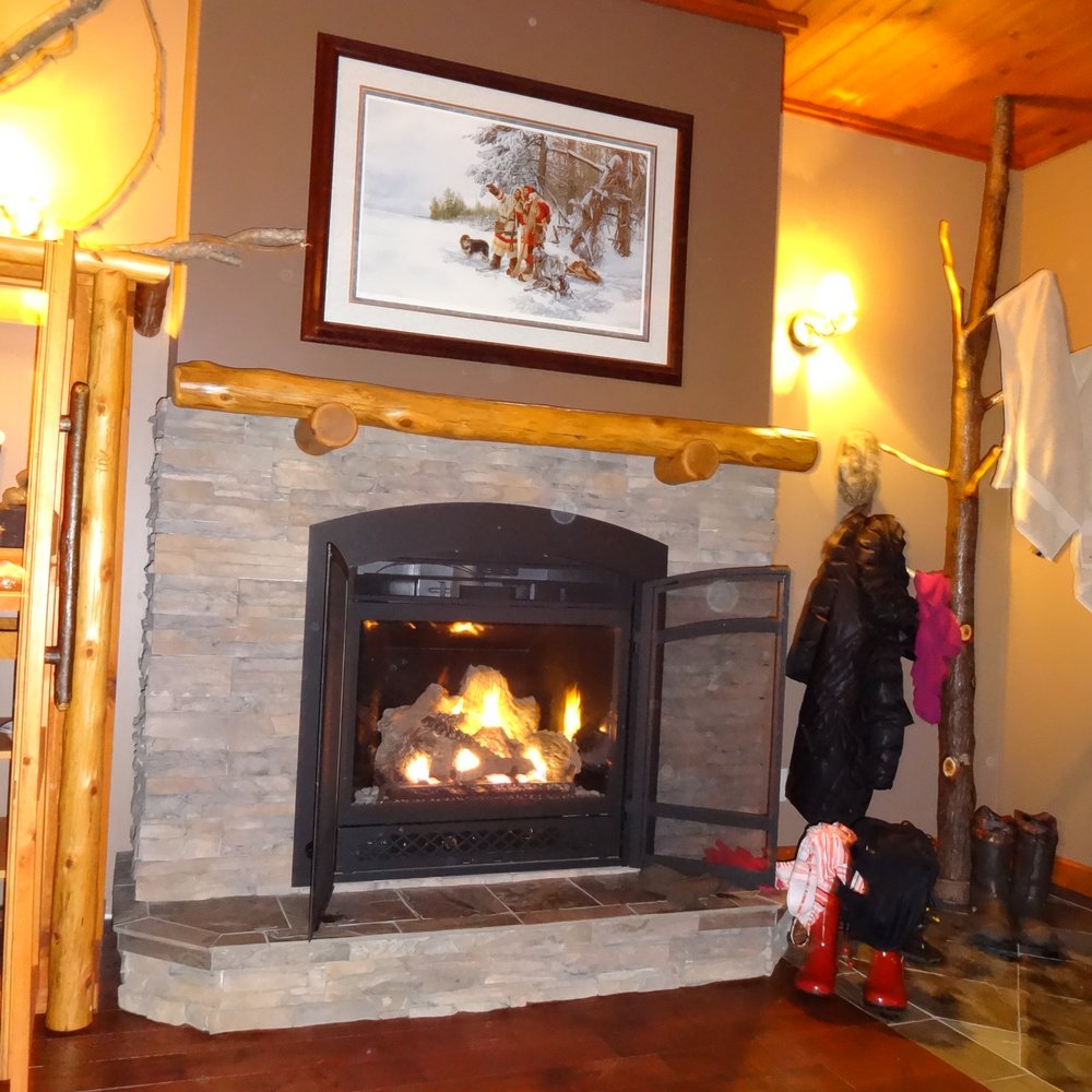 Black River Retreat - The fire place in your suite, our clothing and bathing suits drying on the hand made coat rack. - Hotels Near Me - Tweed, Ontario