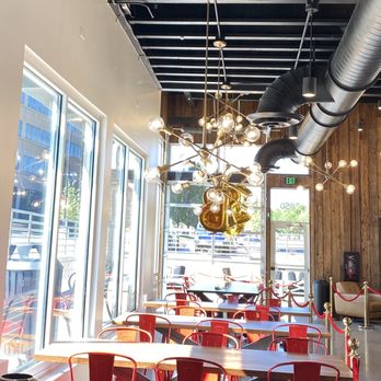 Black Rock Coffee Bar - tables and red chairs - Coffee & Tea Near Me - Denver, Colorado