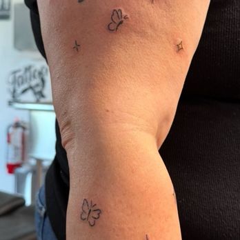 Revival Tattoo Collective - Small butterflies, stars, and sprites freckled on my arm - Tattoo Near Me - Largo, Florida Revival Tattoo Collective - Small butterflies, stars, and sprites freckled on my arm - Tattoo Near Me - Largo, Florida