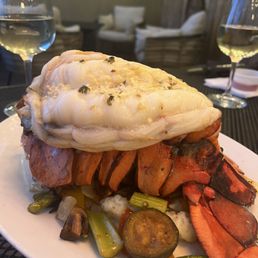 a plate of food and a glass of wine a plate of food and a glass of wine