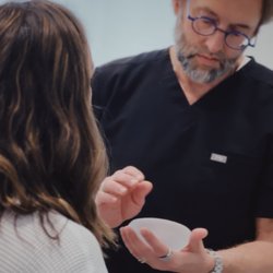 Montante Plastic Surgery & Aesthetics - Dr. Steven Montante discussing breast implant options with a patient during a personalized consultation.