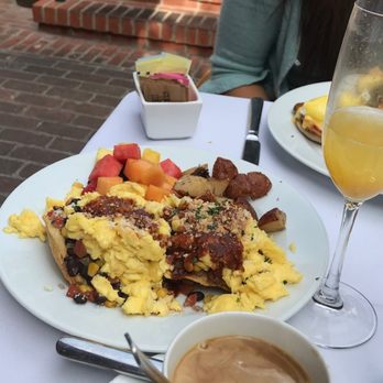 The Raymond 1886 - Huevos Montuleños Scrambled Eggs on Crispy Tortillas with Black Bean Chicken & Corn Salsa, Topped with Roasted Tomato-Guajillo Chile Sauce - New American Near Me - Pasadena, California The Raymond 1886 - Huevos Montuleños Scrambled Eggs on Crispy Tortillas with Black Bean Chicken & Corn Salsa, Topped with Roasted Tomato-Guajillo Chile Sauce - New American Near Me - Pasadena, California