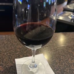 a glass of wine on a napkin a glass of wine on a napkin