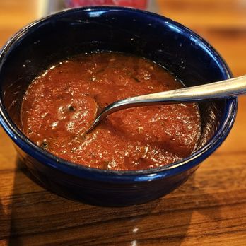 Inovasi - a bowl of soup with a spoon in it - New American Near Me - Lake Bluff, Illinois