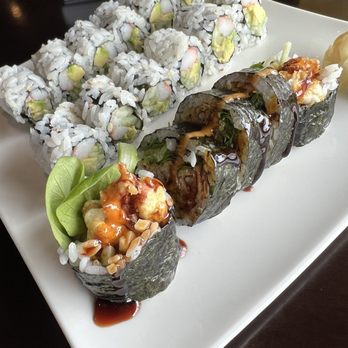 Ooka - California Roll & Spicy Snow Crab Roll - A plate of sushi featuring California rolls with avocado and crab, alongside seaweed-wrapped rolls topped with sauce, served with wasabi and ginger. - Sushi Bars Near Me - Apple Valley, Minnesota
