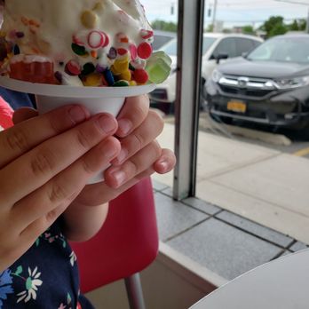 Carvel - a woman eating an ice cream sundae - Ice Cream & Frozen Yogurt Near Me - Bethpage, New York