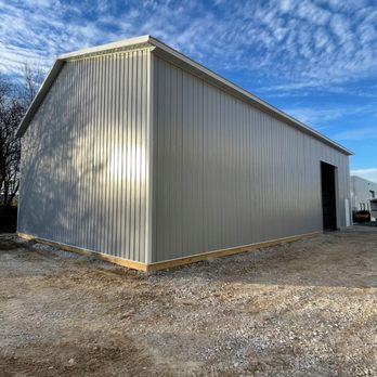 Tailored Construction - a large metal building with a sky background - General Contractors Near Me