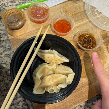 Milk Tea Cafe - Chicken Dumplings with the sauce I'm pointing to is pure heaven - Taiwanese Near Me - Kissimmee, Florida