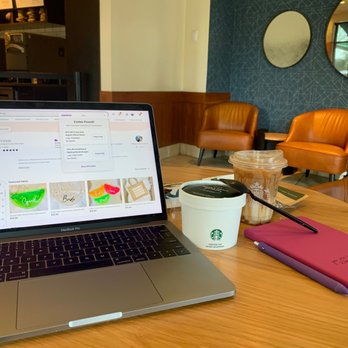 Starbucks - a laptop and a cup of coffee on a table - Coffee & Tea Near Me - Coconut Creek, Florida