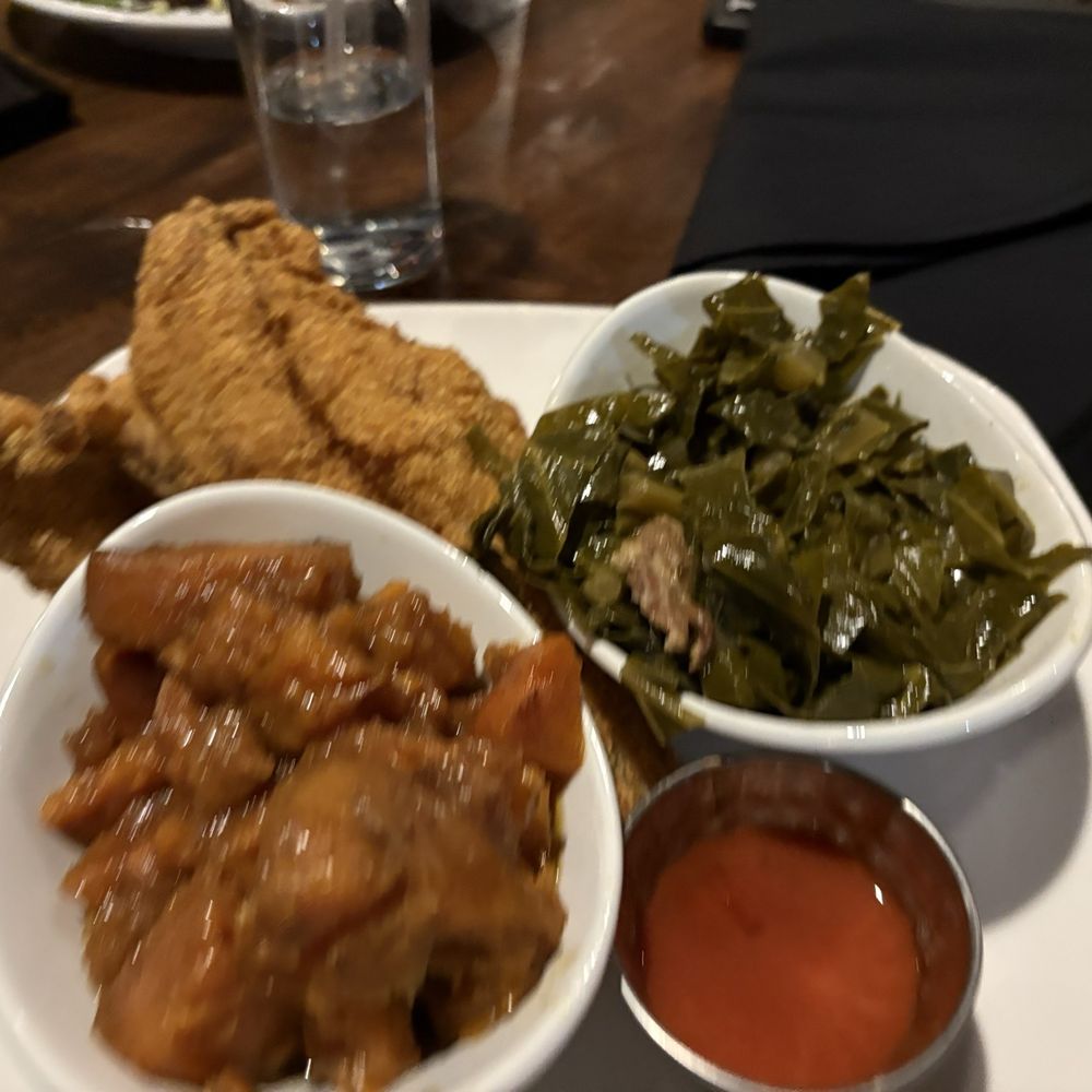 SavannahBlue - Fried catfish plate with greens, candied yams and hot honey hot sauce. - New American Near Me - Detroit, Michigan SavannahBlue - Fried catfish plate with greens, candied yams and hot honey hot sauce. - New American Near Me - Detroit, Michigan