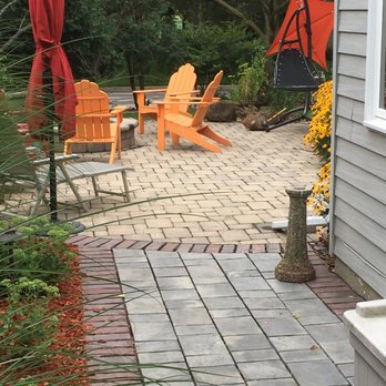 Greenscapes - a patio with chairs and an umbrella - Snow Removal Near Me - Oregon, Wisconsin Greenscapes - a patio with chairs and an umbrella - Snow Removal Near Me - Oregon, Wisconsin