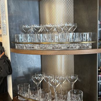 Kilogram - a display of wine glasses on a shelf - Coffee & Tea Near Me - New York, New York