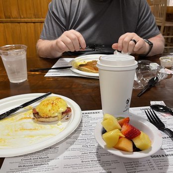 Sunrise Grill - a man sitting at a table with a plate of food and a cup of coffee - American Near Me - Boone, North Carolina