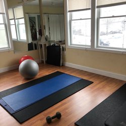 Core Strength and Conditioning - Yoga room with weights, mats, and balance balls