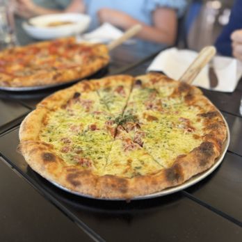 Renee's Tucson - Pesto Pizza in foreground and Everything Pizza in background - Pizza Near Me - Tucson, Arizona