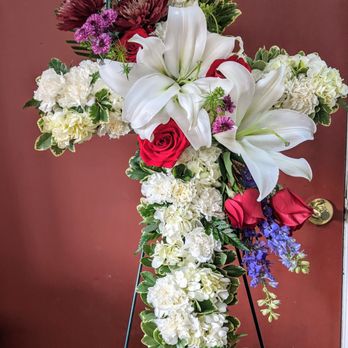 Seatac Buds & Blooms - Cross Wreath. Lilies, Roses, Larkspur, Buttons, Cushion, - Florists Near Me - SeaTac, Washington Seatac Buds & Blooms - Cross Wreath. Lilies, Roses, Larkspur, Buttons, Cushion, - Florists Near Me - SeaTac, Washington