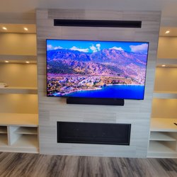 Large Flat Panel TV and sound bar, all part of a beautiful audio video system sold by Mile High Audio Video