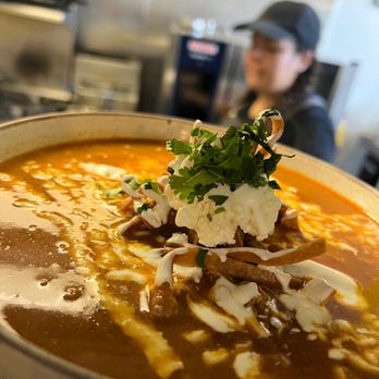 Maizal RMF - a bowl of soup and a person in the background - Mexican Near Me - Vancouver, British Columbia