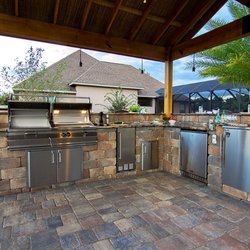 Extreme Contracting Group - Outdoor Kitchen area under a Pergola with brick pavers