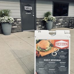 Exterior outside entrance of Uptown Bar and Grill - The front and a tp sign with specials - Grimes, Iowa Exterior outside entrance of Uptown Bar and Grill - The front and a tp sign with specials - Grimes, Iowa