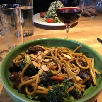 Doc B's Restaurant + Bar - Wok out bowl with the Brussels sprouts salad hiding behind the glass of pinot. Delicious! - New American Near Me - Fort Worth, Texas