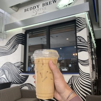 Buddy Brew Coffee - Sarasota - a hand holding a cup of iced coffee - Coffee & Tea Near Me - Sarasota, Florida