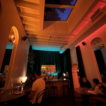Paris Paris - people sitting at a table in a dimly lit restaurant - Wine Bars Near Me - Toronto, Ontario
