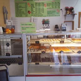 a counter with a variety of pastries a counter with a variety of pastries