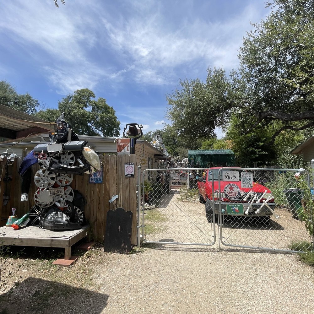 Out front -- you can see some of the "junk" past the gate in the backyard