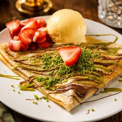 Donnas Crepes & Panini - Indulgent crepe loaded with rich Belgian chocolate, silky pistachio cream & crunchy kataifi, finished with fresh strawberries.