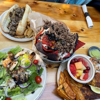 Seacrets - Cheesesteak sandwich, chicken salad, nachos, and seafood platter (served on paper plates ) - Bars Near Me - Ocean City, Maryland