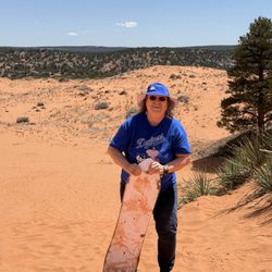 Zion Adventures - Boarding down the sand dune.  The climb back up the sand dune was arduous for a 76 year-