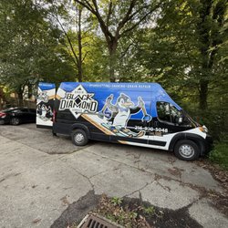 Black Diamond Plumbing and Drain - Drain cleaning van parked in rental property parking lot