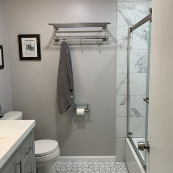 Set In Stone - a bathroom with a shower, toilet, and sink - General Contractors Near Me