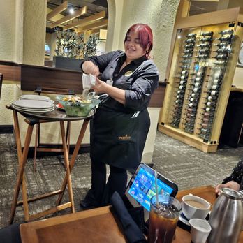 Olive Garden Italian Restaurant - Natalie, our super nice waitress spreading up the parmessan cheese for our salad - Italian Near Me - Modesto, California Olive Garden Italian Restaurant - Natalie, our super nice waitress spreading up the parmessan cheese for our salad - Italian Near Me - Modesto, California