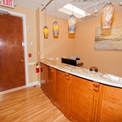 Kupchik Dental - Our waiting room and front desk - you won't be here long, we pride ourselves on our quick turnaround time.