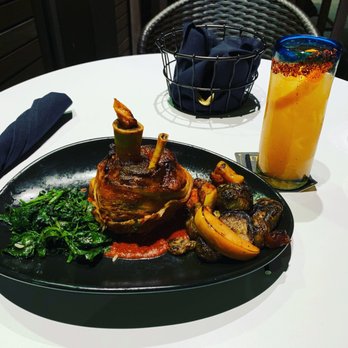 Xochi - Braised pork with a Paloma drink with mezcal - Mexican Near Me - Houston, Texas