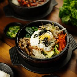 Chris Korean BBQ - Bibimbap options: Meat, Kimchi, Spicy Squid, and Vegetarian. Pictured: Spicy Squid Bibimbap (back) and Vegetarian Bibimbap (front).